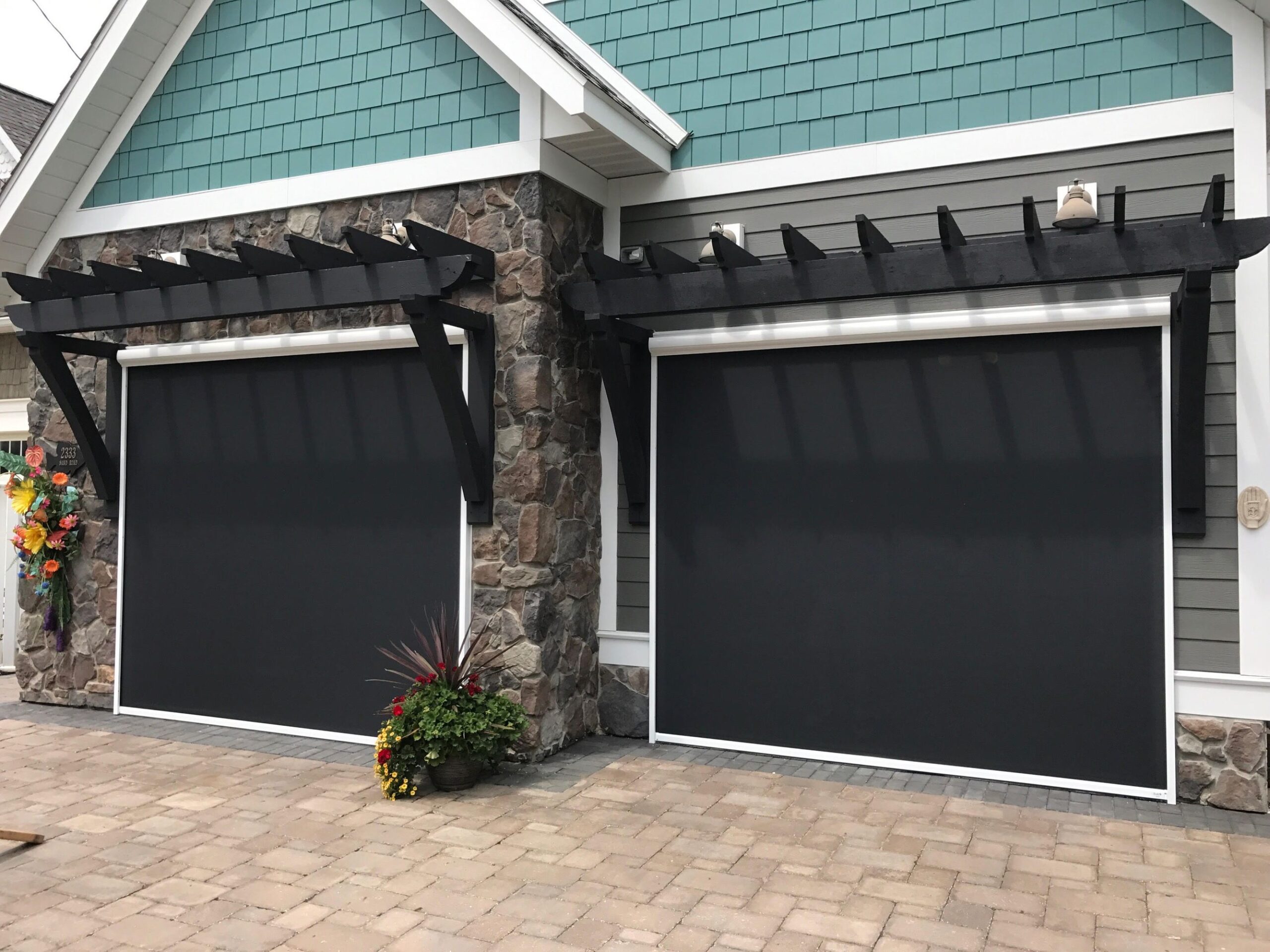 A contemporary garage door adorned with elegant black roller shades