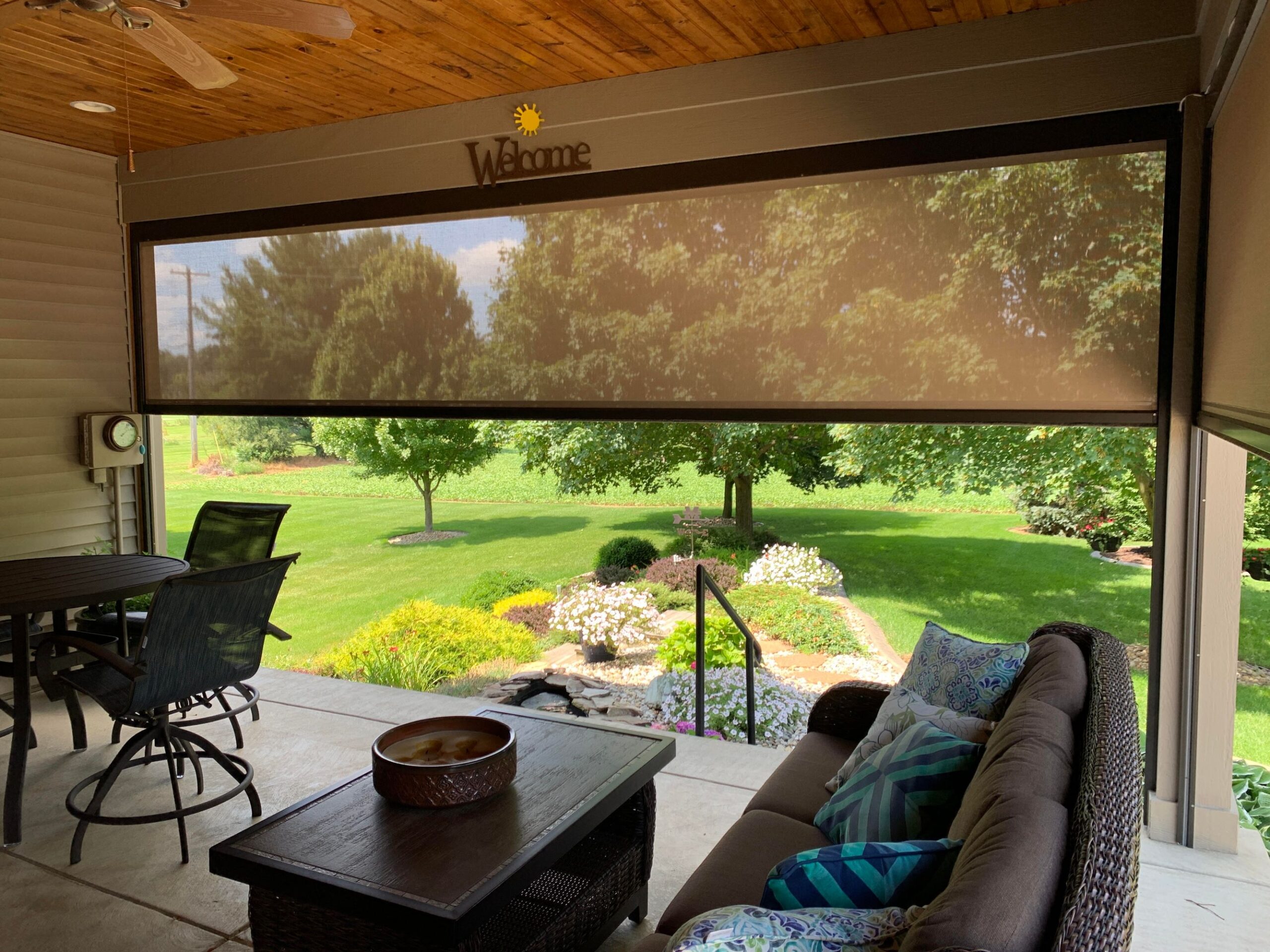 A cozy patio featuring a table and chairs positioned beneath a large window